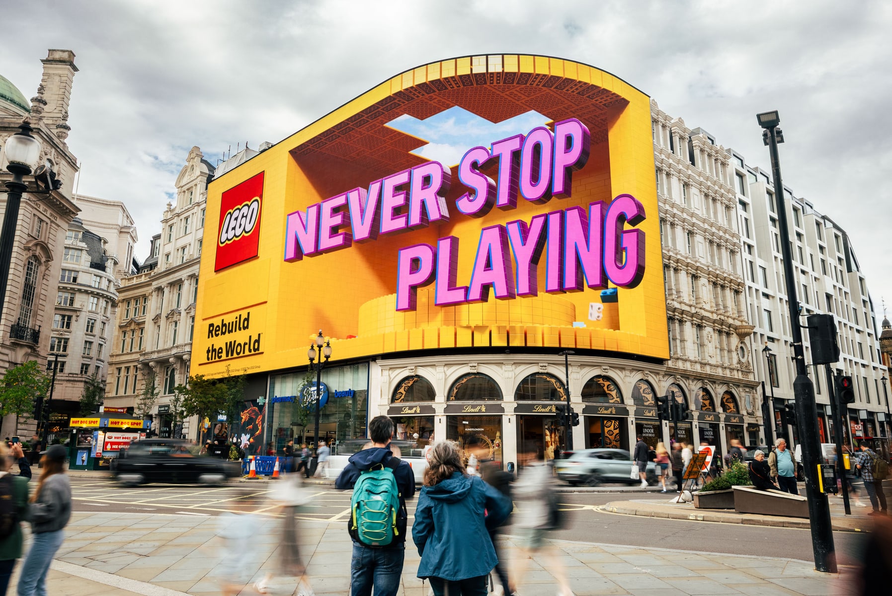 Large digital billboard in a London urban square running a Balenciaga campaign with a model lounging in streetwear, booked programmatically through Blindspot