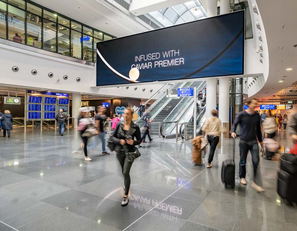 Frankfurt Airport, Departures hall · digital pillar network, real DOOH inventory bookable by the hour on Blindspot