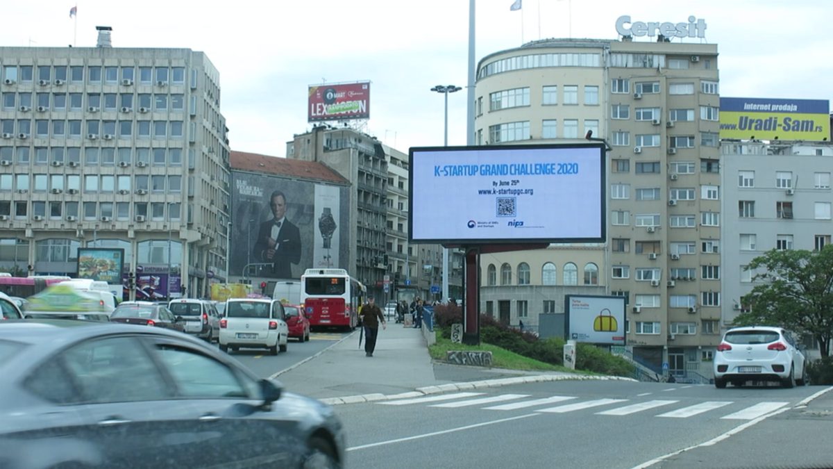 K-Startup Grand Challenge 2020 creative on a digital billboard above a busy Belgrade street in Serbia