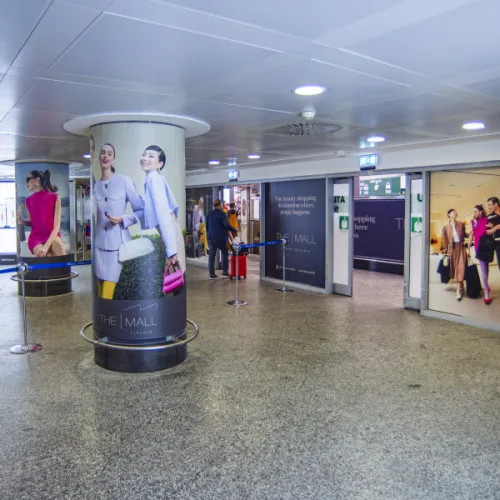 Milan Malpensa Airport, Arrivals corridor · animation lightbox, real DOOH inventory bookable by the hour on Blindspot