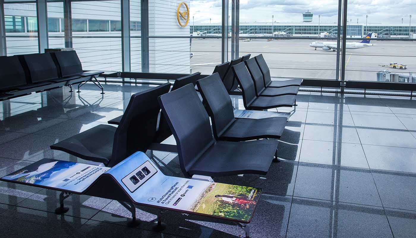 Munich Airport, Gate concourse · holdroom screens, real DOOH inventory bookable by the hour on Blindspot