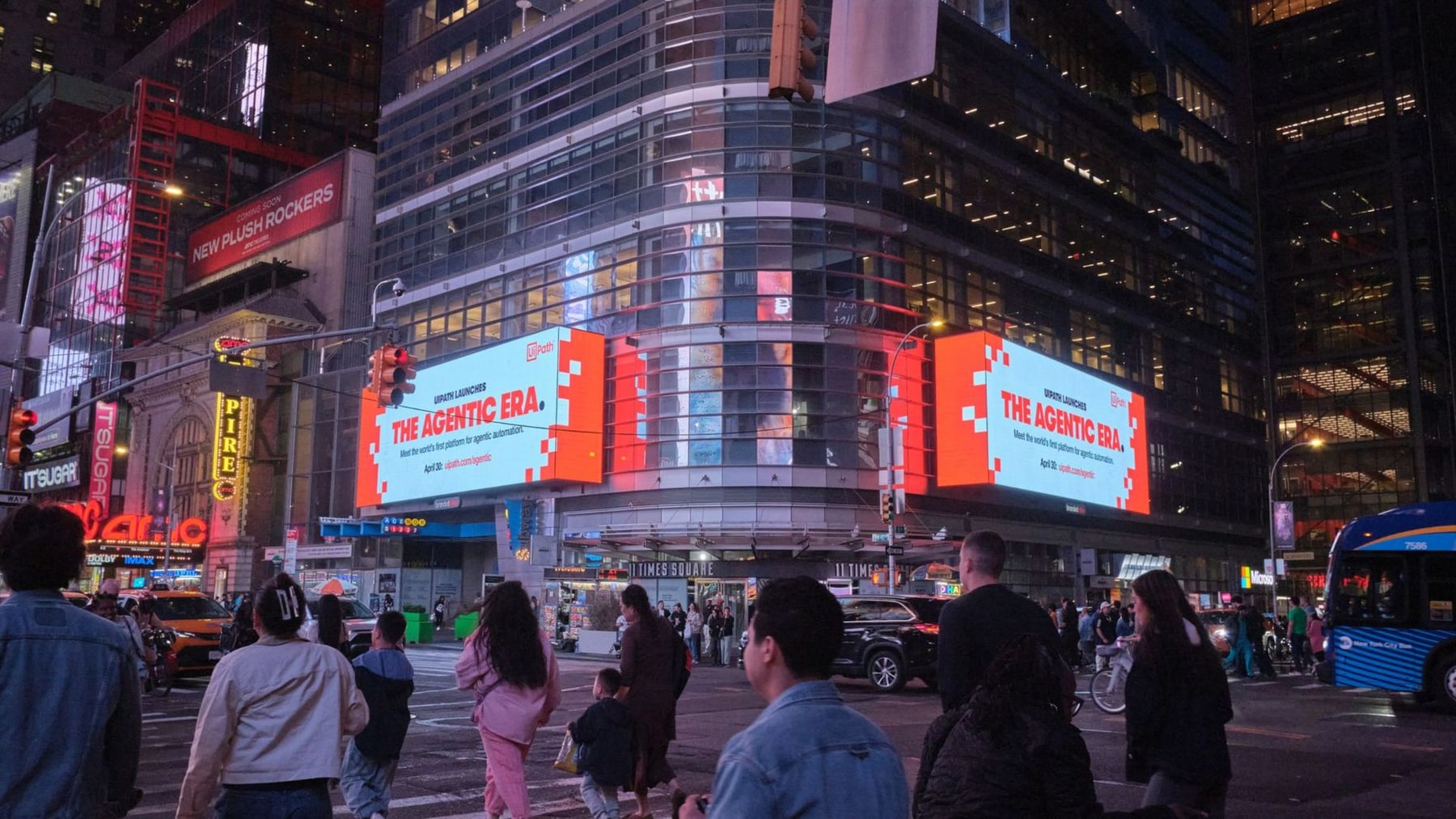 UiPath 'The Agentic Era' product launch campaign wrapped around the Nasdaq tower billboard in Times Square, surrounded by competing DOOH screens on West 43rd Street in Midtown Manhattan