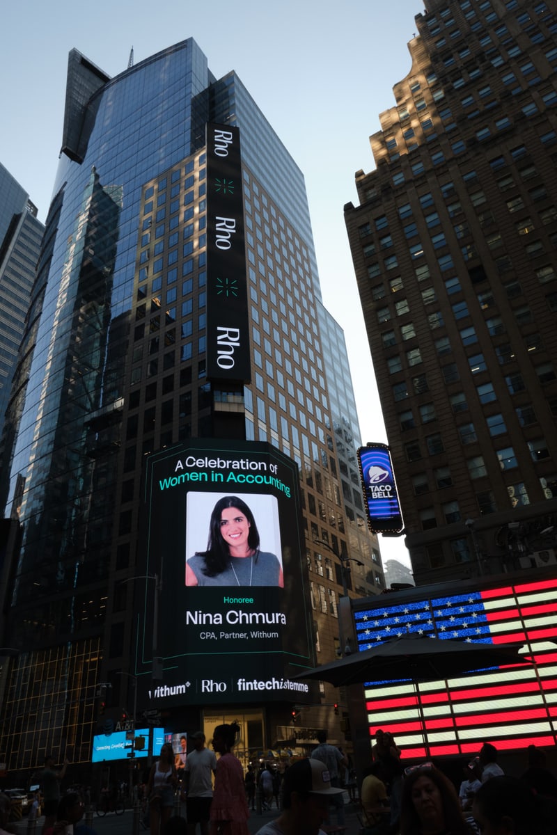 Times Square large-format digital billboard honoring Nina Chmura, CPA Partner at Withum, part of the Celebration of Women in Accounting campaign sponsored by Withum, Rho, and Fintechistemme, in Midtown Manhattan
