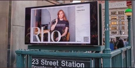 Rho campaign on a digital screen above the 23rd Street subway station entrance in Manhattan