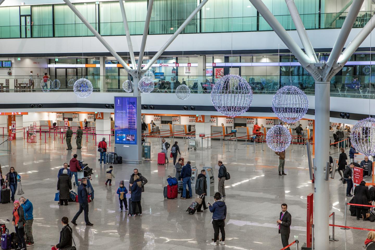 Warsaw Chopin Airport, Gate concourse · holdroom screens, real DOOH inventory bookable by the hour on Blindspot