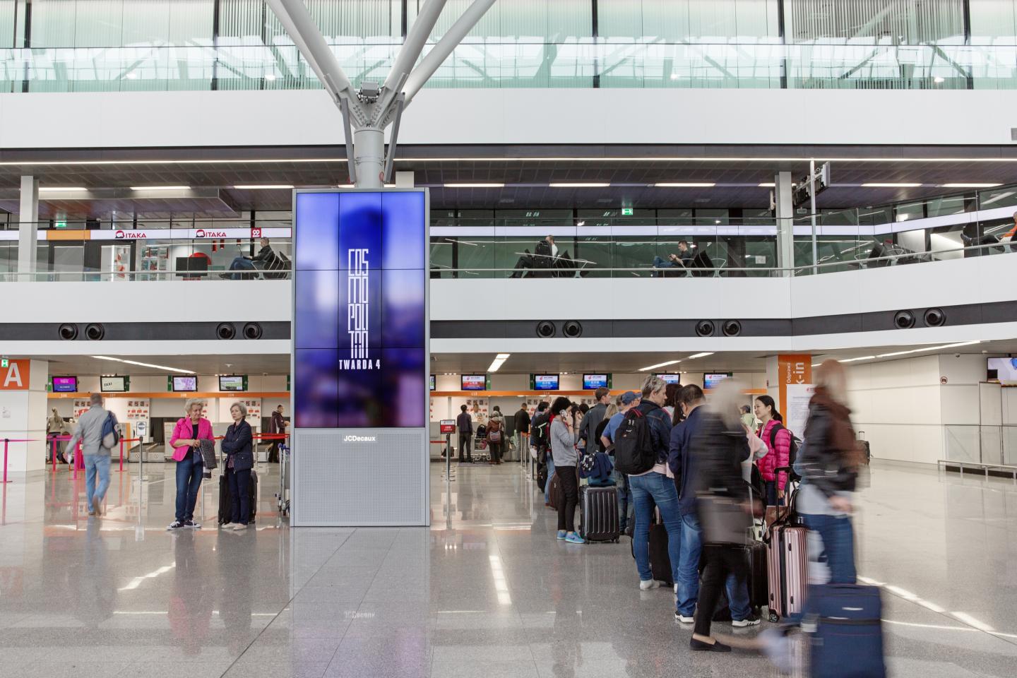 Warsaw Chopin Airport, Arrivals corridor · animation lightbox, real DOOH inventory bookable by the hour on Blindspot
