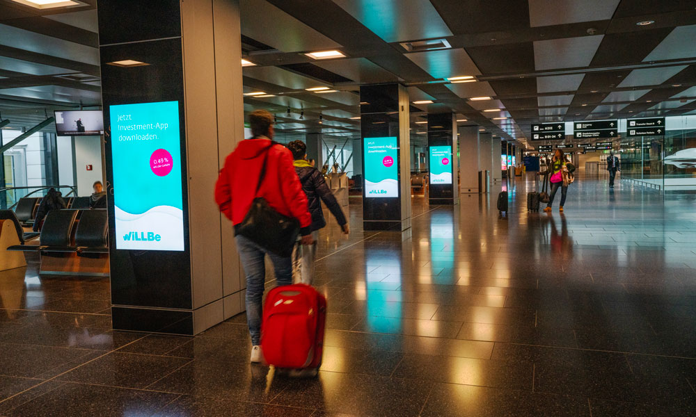 Zurich Airport, Gate concourse · holdroom screens, real DOOH inventory bookable by the hour on Blindspot